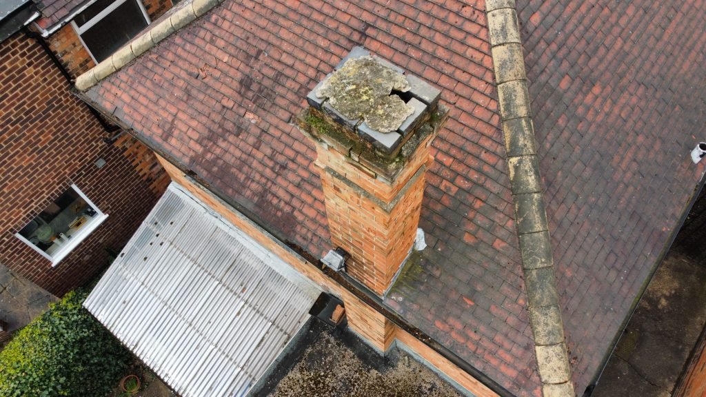 Aerial drone photograph of a damaged chimney stack and roof