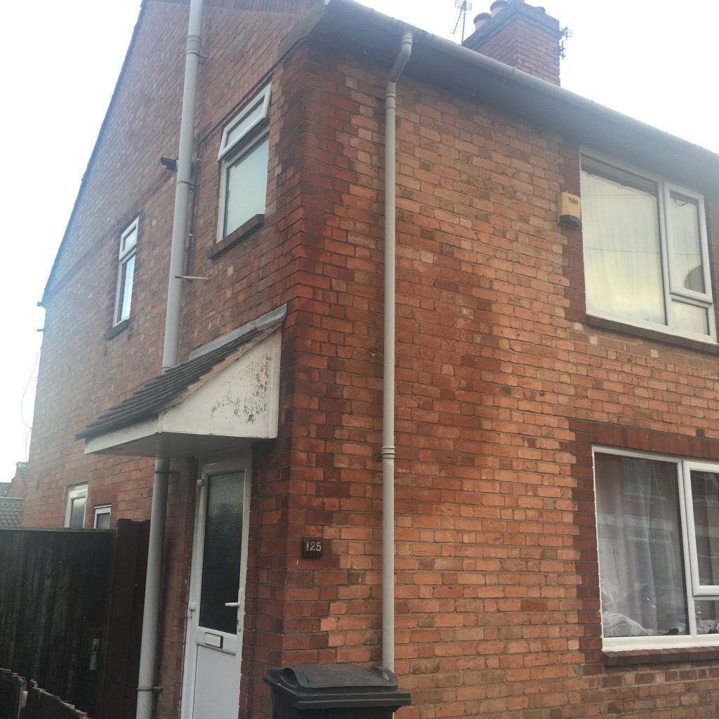 Damp patch on a ceiling caused by blocked guttering