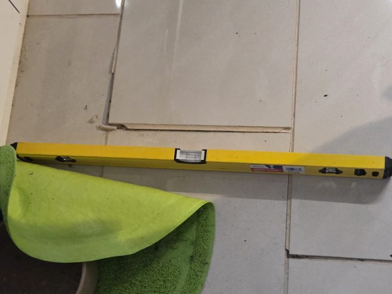 Crystalline deposits beneath a lifted floor tile, evidence of sulphate attack